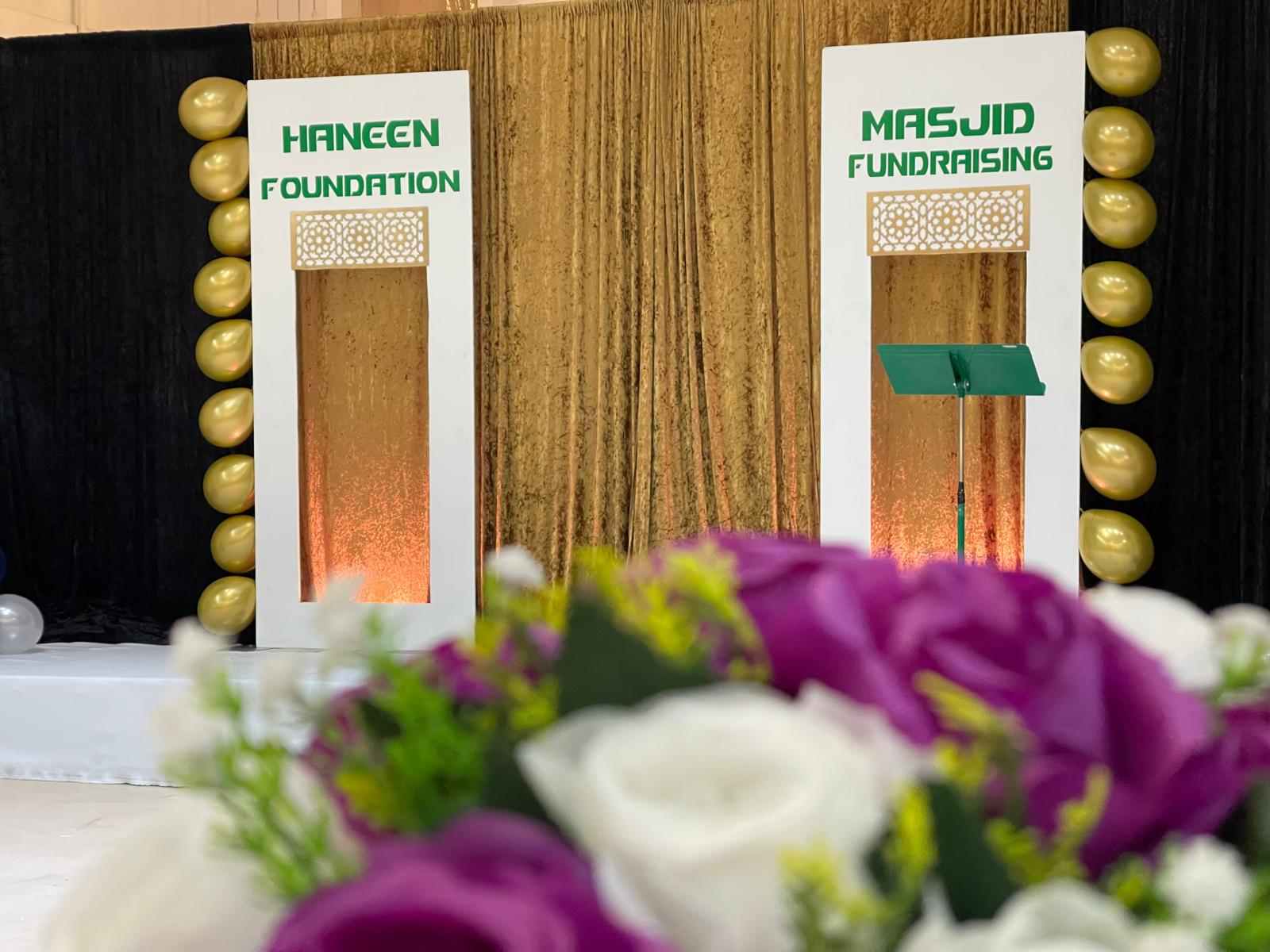 Professional stage and backdrop setup for a community fundraising event