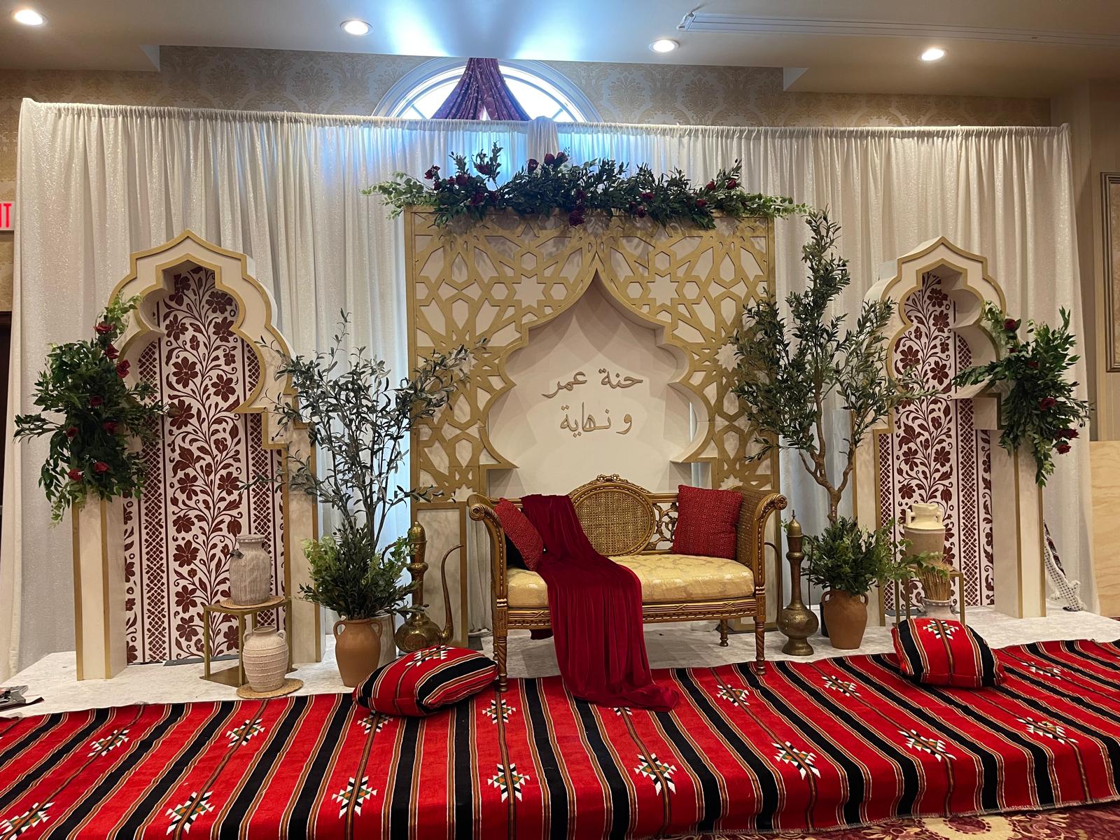 Moroccan-inspired henna stage backdrop lit for a wedding celebration — Pixel N Sound Events, New York
